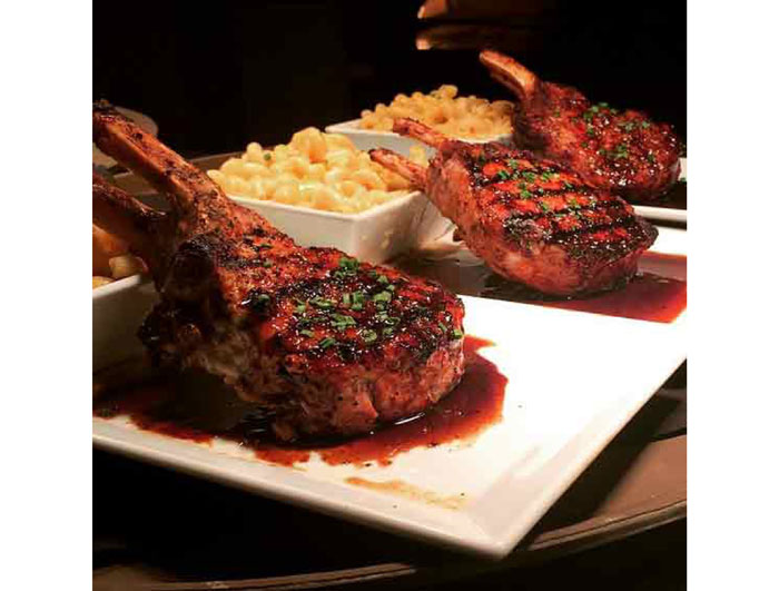 The double-cut pork chops at Davis Street are grilled and topped with a balsamic mustard reduction and served with macaroni and cheese. Photo courtesy Davis Street. 