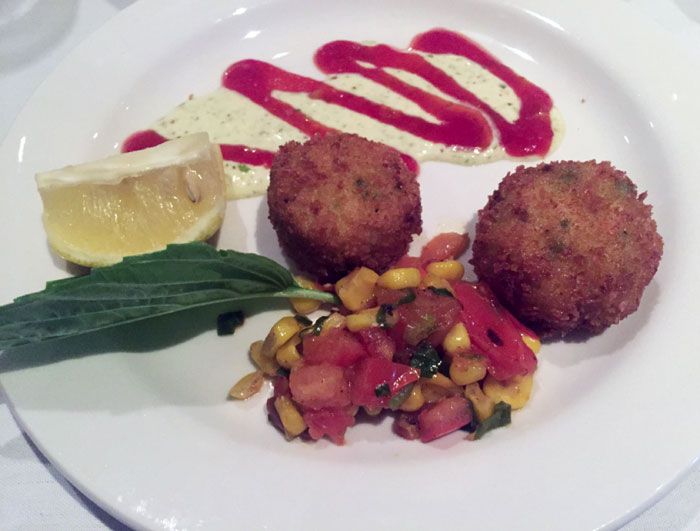 Ouisie's Table's crispy mini crab cakes are served with corn relish.