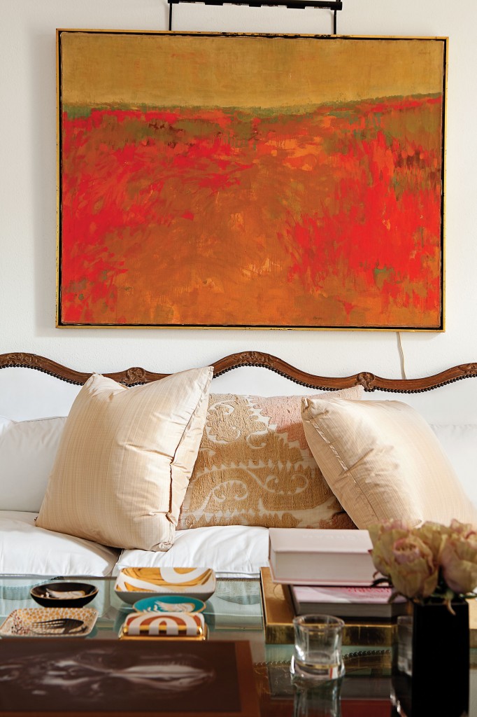 In the salon, an oil painting from the estate of Herb Wells hangs above an 18th-century French Louis XIV sofa from James Powell, Austin, covered in white cotton. Pillows in pink strie silk by Rose Tarlow from George Cameron Nash. Vintage textile pillow from Thompson Hanson. Wayland Gregory porcelain ashtrays and box from Sloan/Hall.