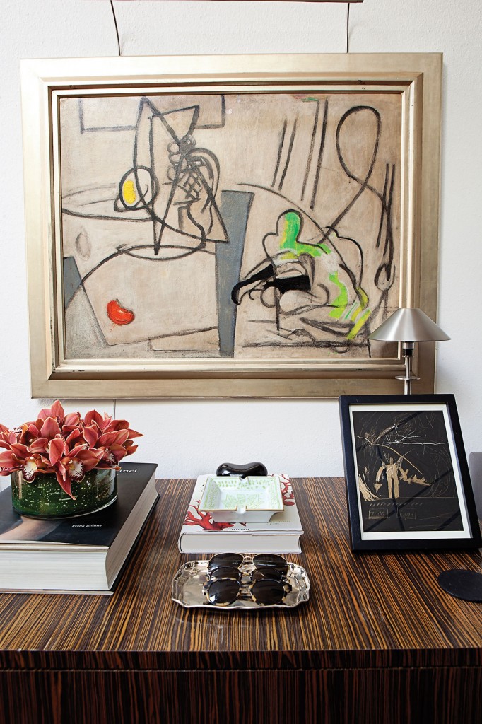 Tigerwood chest is beneath an American Expressionist painting by Jane Piper from McClain Gallery. Flowers by David Brown.