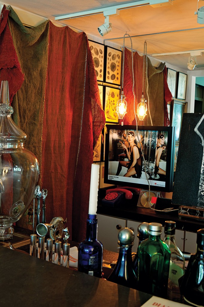 Vintage Afghani tent hanging cordons off the drinks bar, shot with a framed Mario Testino Kate Moss poster.
