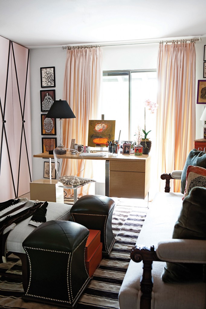 In this office/sitting room, pink-painted wood doors are crisscrossed with black grosgrain ribbon. Black leather stools with chrome nailheads from Area.