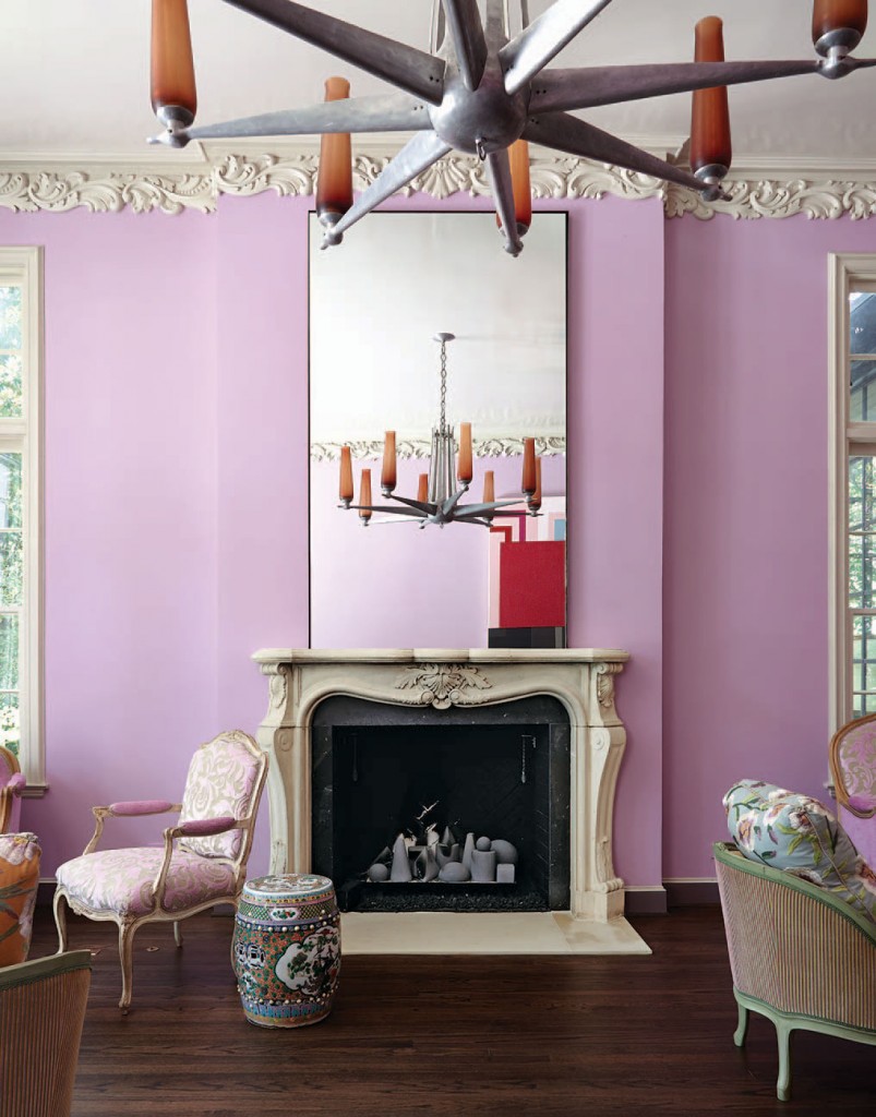 The living-room lilac walls and lacquered ceiling were custom-mixed and applied by Barry A. Martin Painting Contractors. The original plaster molding, fireplace and French antiques contrast with a mid-century chandelier from the Petroleum Club of Houston.