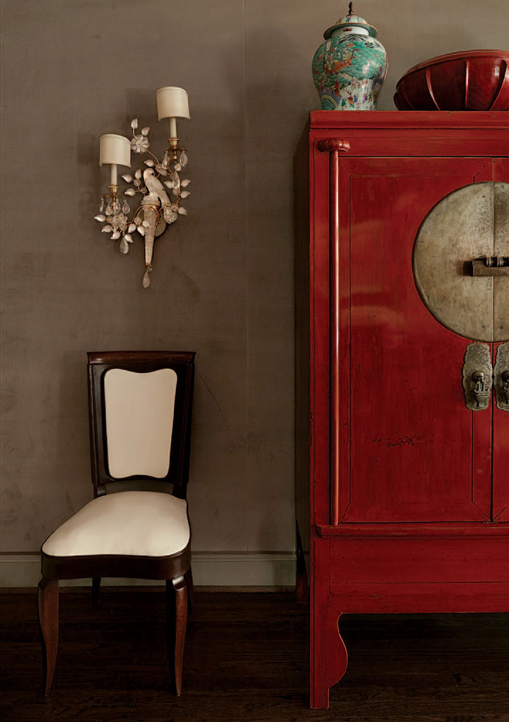 In the dining room are an antique Asian chest and a Chinese vase that belonged to the husband’s parents. The sconce is Baguès, one of a set of four.