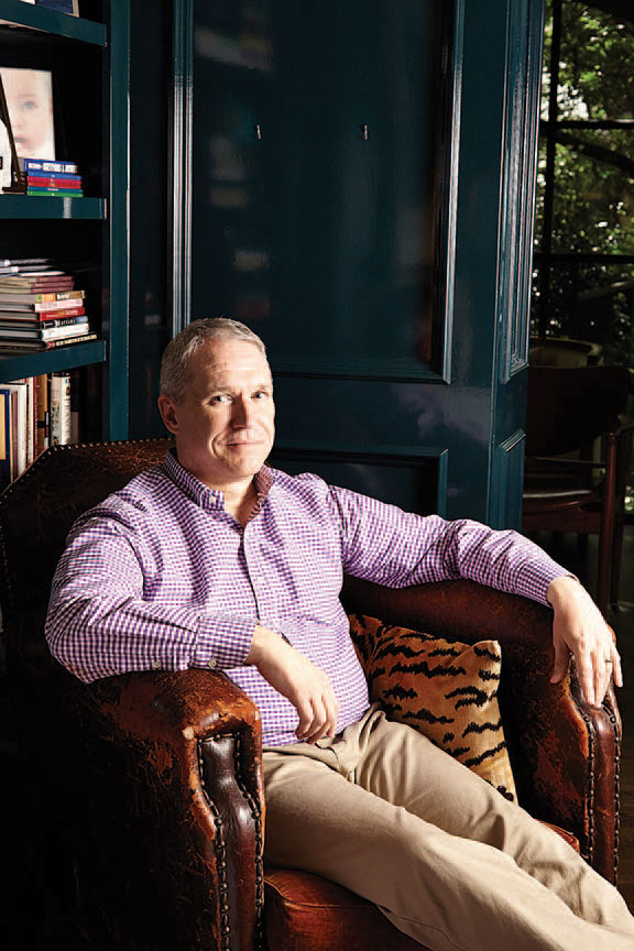Designer Paul Garzotto in the library of the 1931 Colonial Revival home he recently completed for clients.