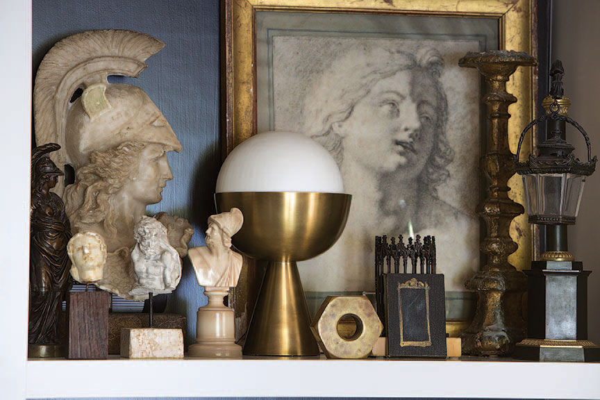 An 18th-century French drawing mixes with marble Grand Tour busts and an Art Deco lamp.