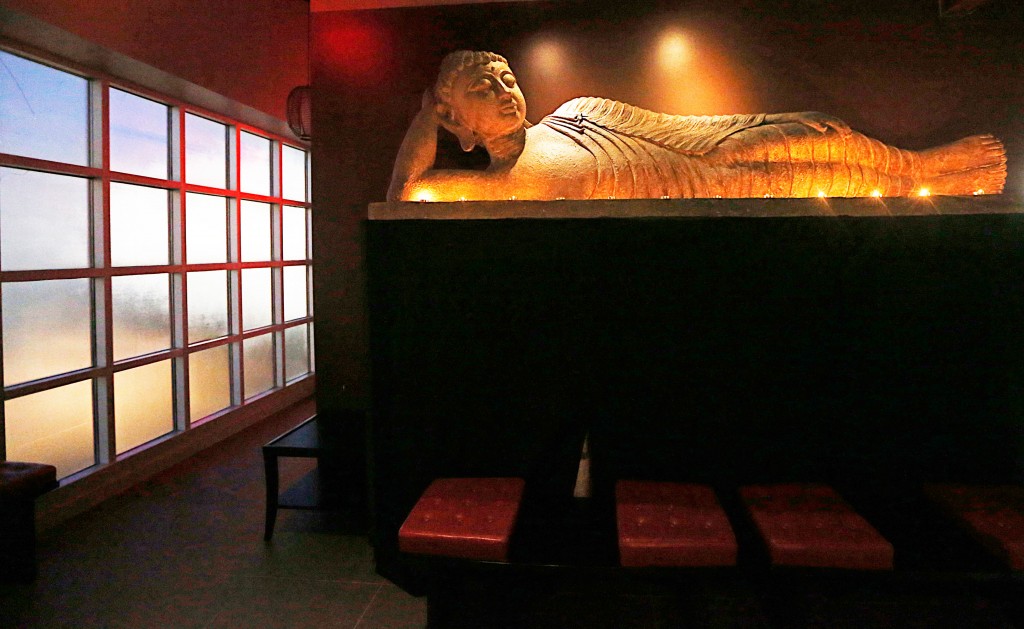 A reclining buddha greets guests before private-room entry. 