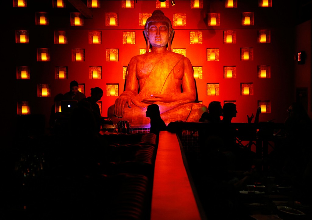 A seated buddha overlooks the main dining room. 