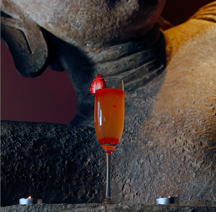 A Champagne Firecracker sits atop the reclining buddha. 