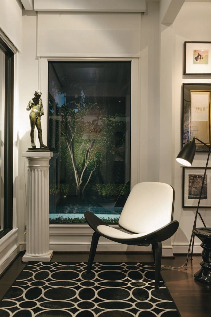 Finn Juhl chair, circa 1950.
Grasshopper floor lamp by Greta Magnusson-Grossman,
circa 1950. Grand Tour bronze. Artwork includes an Andy Warhol skull print and Robert Rauschenberg “Shirt Board” series.