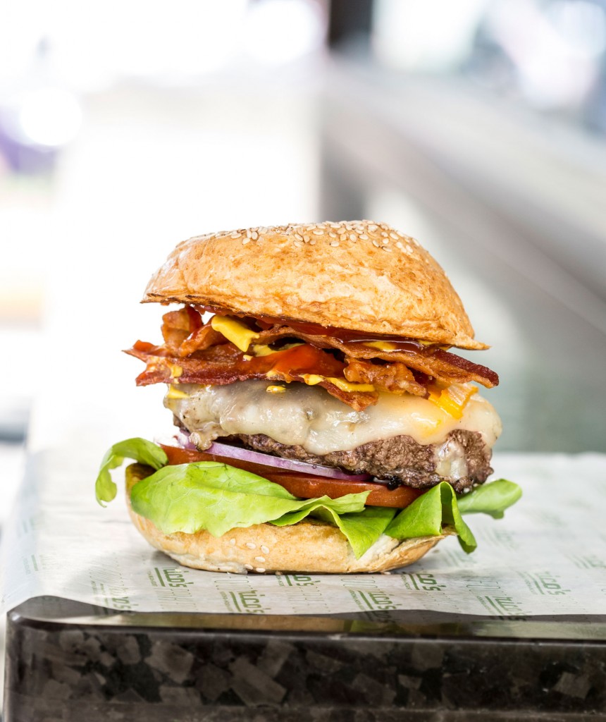 Rico's bacon cheeseburger is topped with cheese, crispy bacon, lettuce, tomatoes, onions, pickles, ketchup and mustard. 