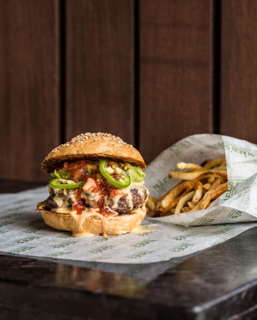 Rico's Tex Mex burger is topped with chile con queso, guacamole, jalepeños and spicy salsa. 