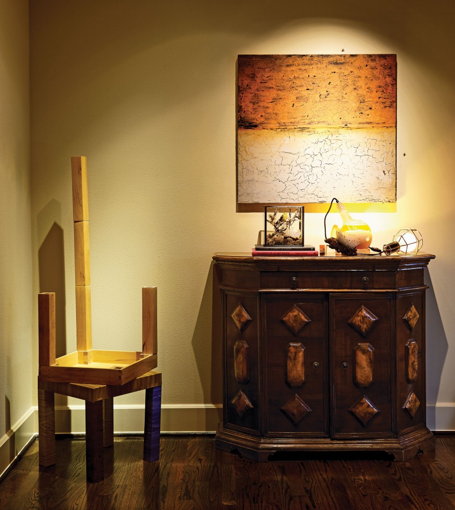 Vernon Fisher’s depiction of an African sunset with parched desert includes freeze-dried flies with thin bronze legs, which the owner of the artwork can place at will. Santiago Cucullu’s Stacked Tables with One Extra Leg, 2001, through Barbara Davis Gallery. German light fixture is filled with lard that creates a glow when heated. Antique Italian console with burl-wood inlay.
