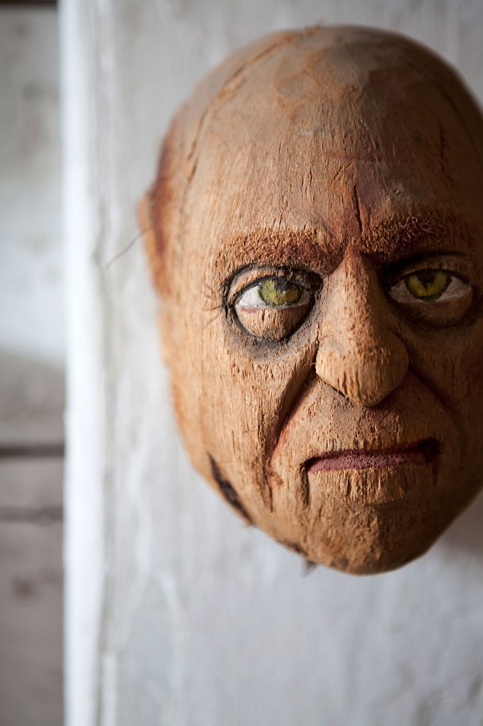 In the living/dining room, a carved coconut head, circa 1940.