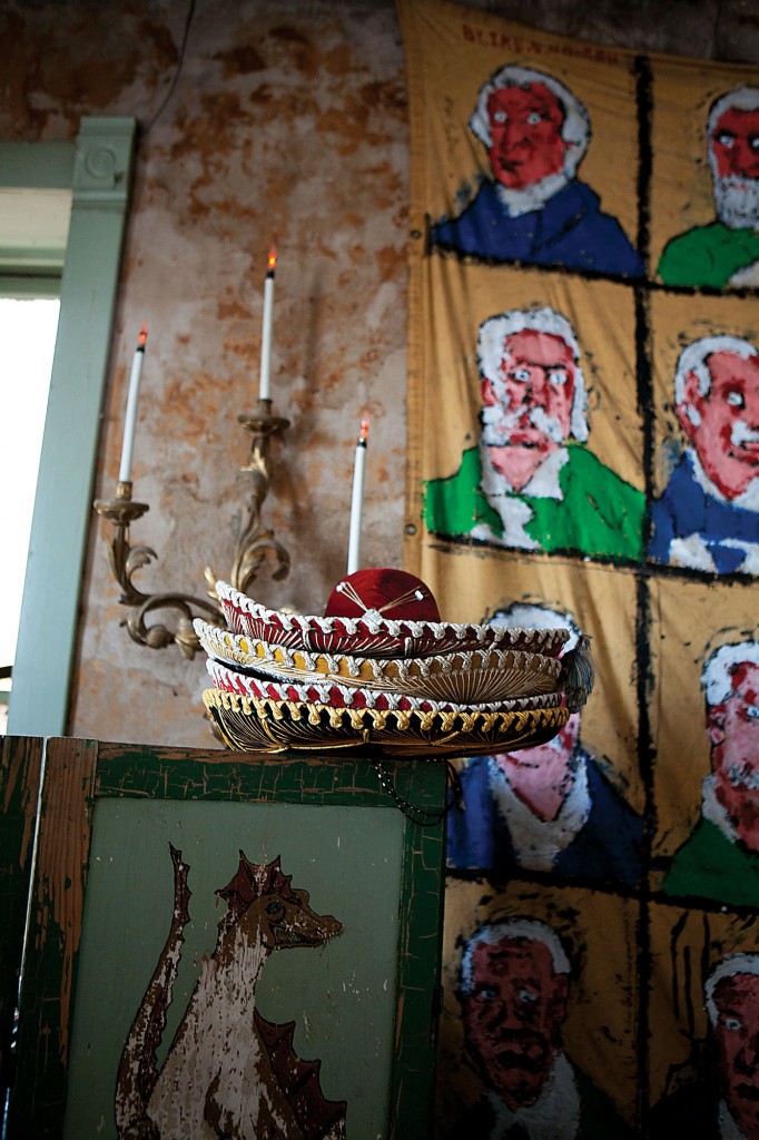 Sombreros, antique French candelabra and Ike Morgan presidential series make for unlikely company in the master bedroom.