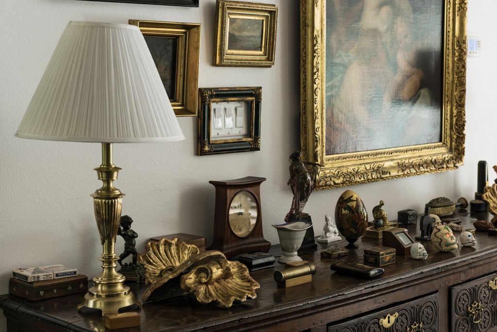 Another view of the keepsakes patinated with history that reside on an early carved console.