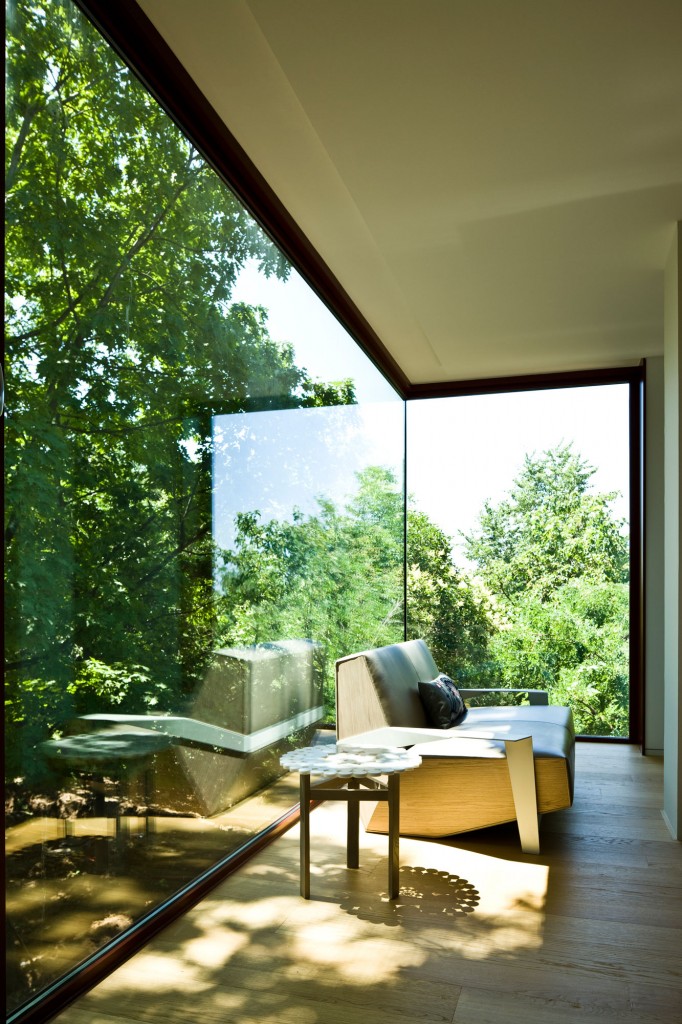 Large windows show off the wooded setting.