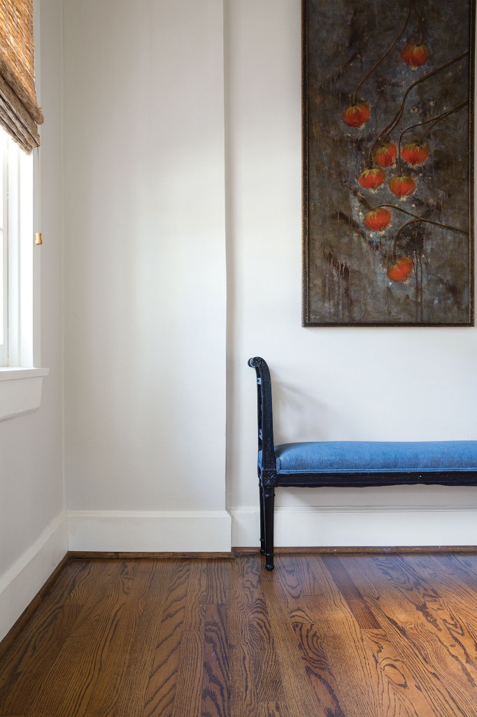 The upstairs hall is dressed with an antique bench covered in Celerie Kemble for Schumacher. The painting previously belonged to Looke’s parents. 