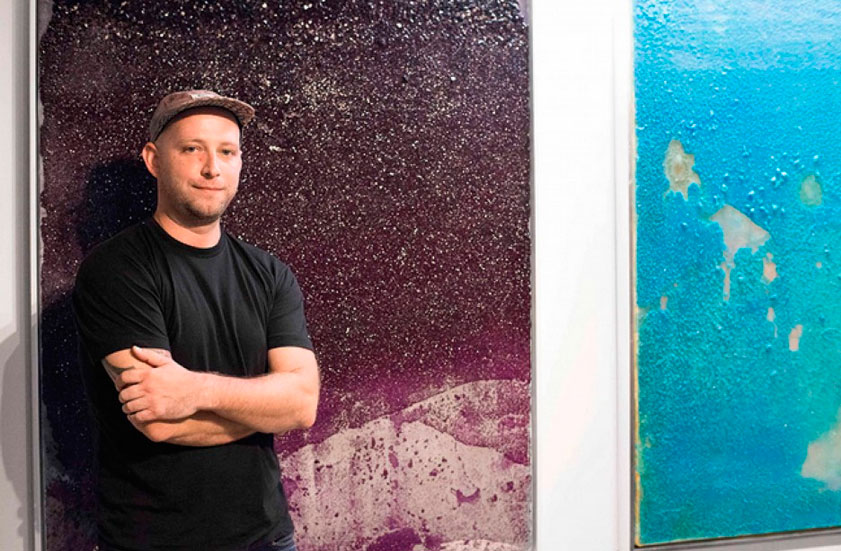 At his studio in the Cardoza Fine Art complex, Bret Shirley with recent crystal-encrusted canvases. Cardoza sold out Shirley's work at the 2015 Texas Contemporary Art Fair.