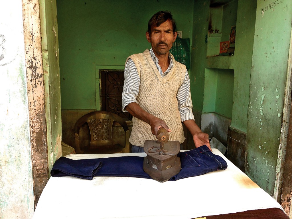 Once fabric is printed, dyed, washed and dried, this man irons each meter of fabric in his storefront in Chippa Mohalla (the printer's quarter), using the same iron generations have used before him.