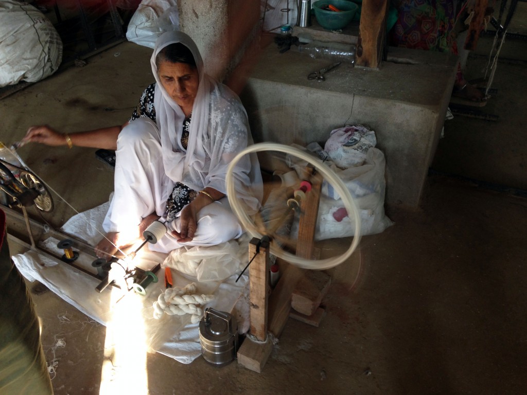 After yarn has been saturated with a paste made of potatoes or rice starch to protect it during the weaving process, it is wound by hand onto bobbins for the looms.