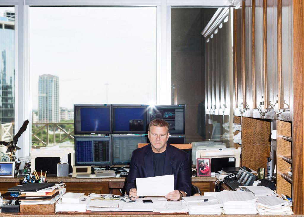 Six monitors are set up behind Tilman Fertitta's huge desk. He really does have eyes in the back of his head. (Photo by Max Burkhalter.)
