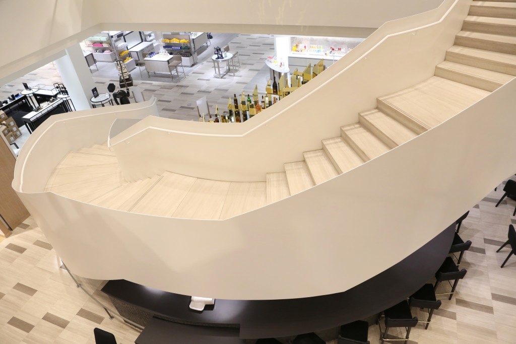 A winding staircase serves as the store's focal point, cascading like a flowing ribbon. (Photo by Priscilla Dickson)