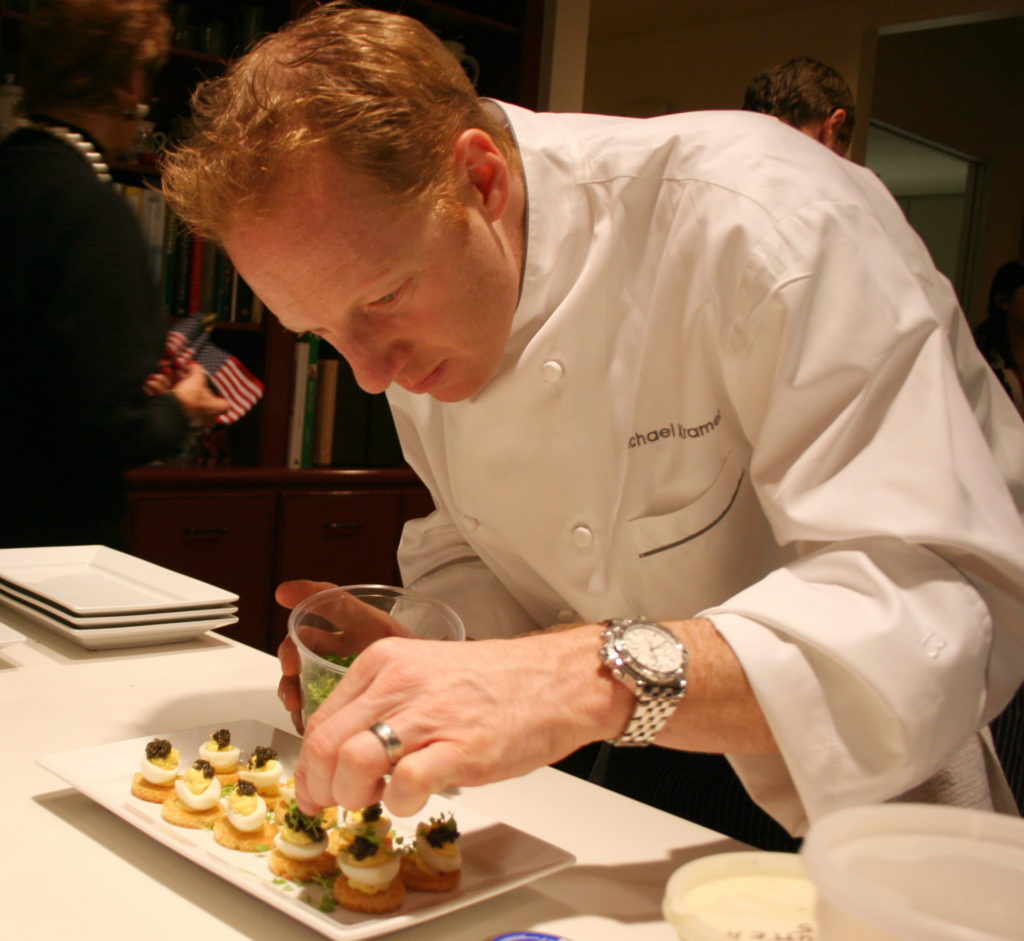 Chef Michael Kramer putting the final touches on one of the glamorous meals orchestrated by Recipe for Success Foundation’s founding chefs through the years. (Photo by Gracie Cavnar)