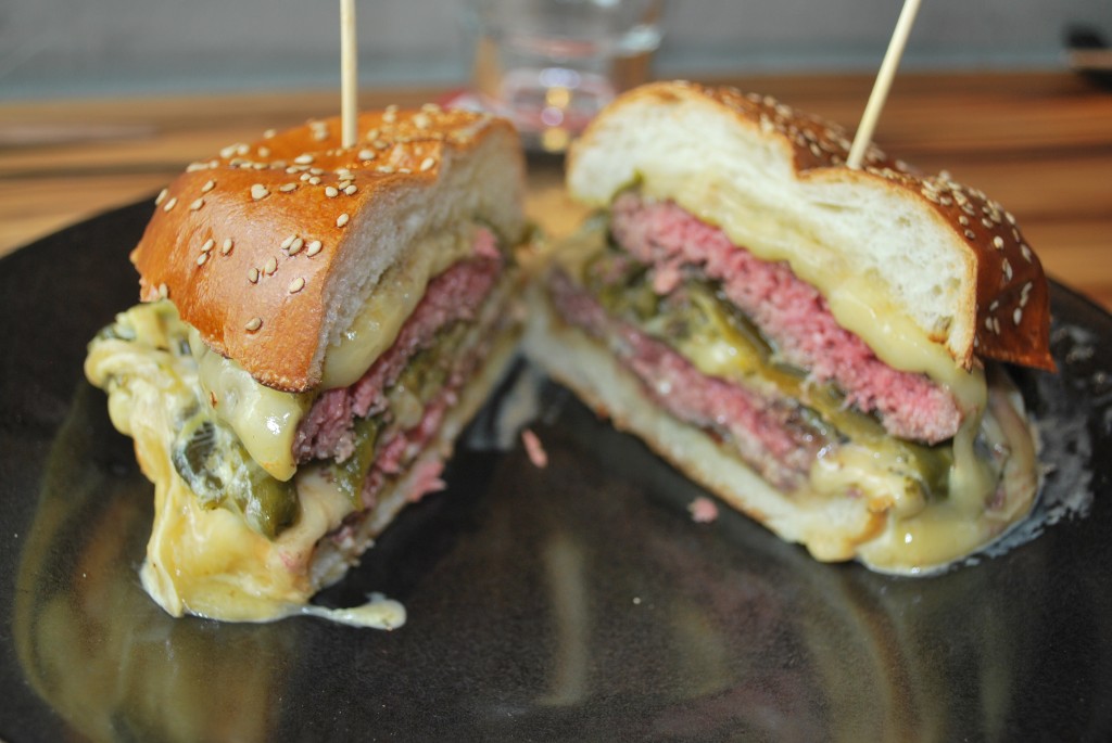Chef Gaston describes his Oowie Goowie Burger, which is smothered with Rajas con queso, as "stoopid amounts of cheese." 