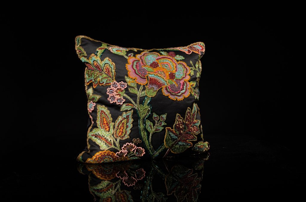 Encrusted Czech glass beads on rainbow floral with jet black fabric; burnt gold metal and silk border braid detail, black velvet welting; charcoal cashmere back with wide French ribbon detail, $2,500