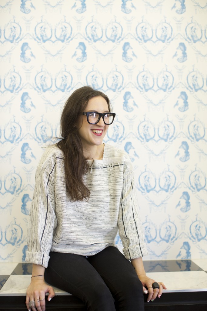 Marquez sits in front of a custom wallpaper designed by artist TK. The image is drawn with blue ink. 