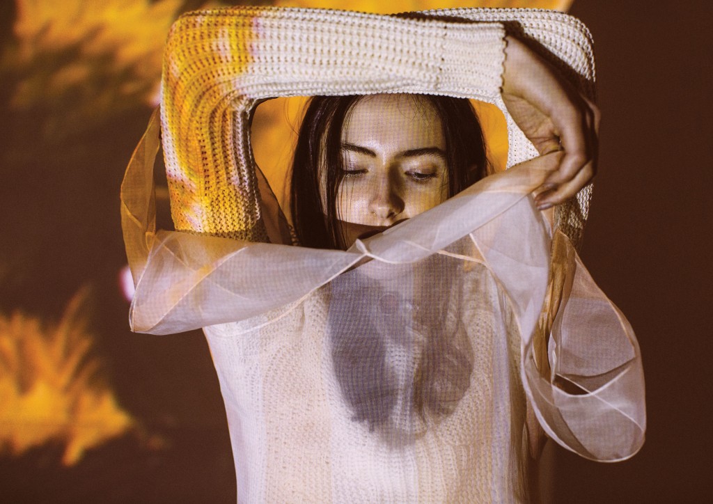 Christian Dior cotton wool sweater $1,300, and silk organza dress $10,500, both at the Christian Dior boutique, Saks Fifth Avenue, Tootsies, The Webster. Artwork: Joey Fauerso’s single-channel video "Guadalupe — After Images," 2014, at David Shelton Gallery, Houston.