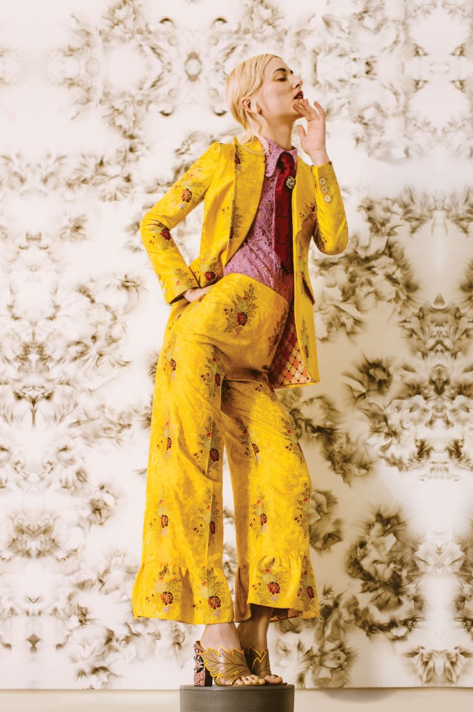 Gucci lace button-down shirt $750, buttercup flower printed fil coupe jacket $4,690, matching boot-cut pant with ruffled cuff $1,990, red-roses-and-leaves jacquard tie $325, pin with swarovski crystals $580, and crossover leather sandal slide with stud and snake detail $1,100, all at the Gucci boutique, Neiman Marcus, Saks Fifth Avenue, The Webster.