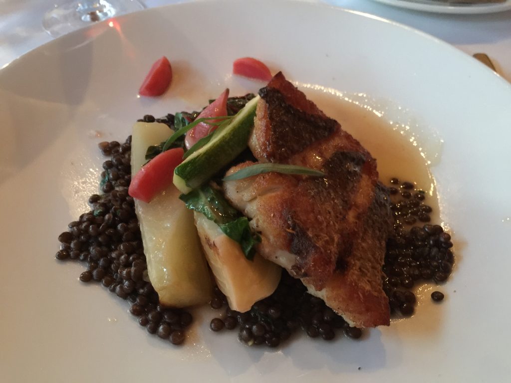 A seafood course: red snapper, lentils, and pickled radishes