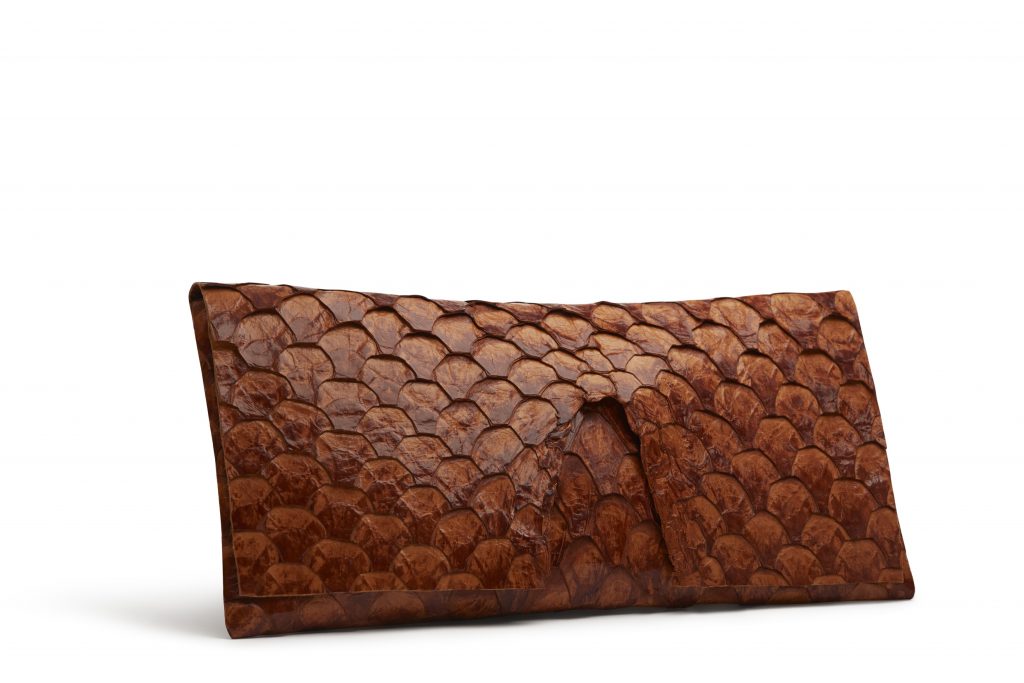 Oversized pirarucu skin clutch in cognac, $2,875
