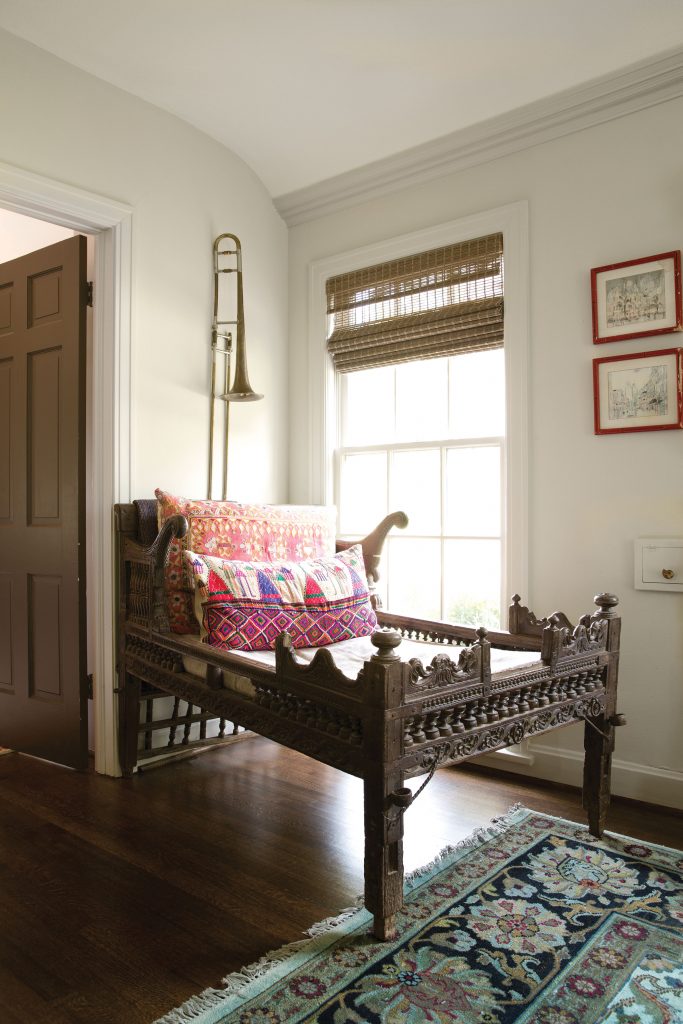 An Indian howdah with pillows made from old dowry bags serves as a daybed in the living room.