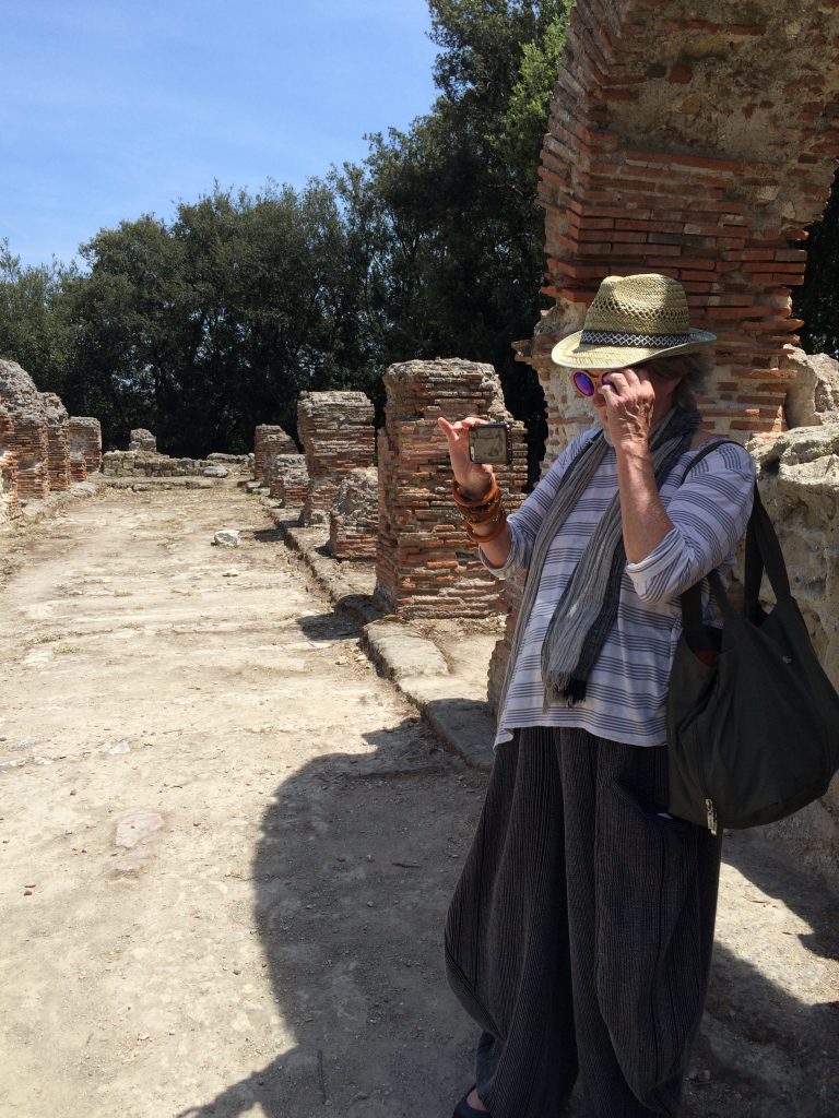 Author and artist Mary Margaret Hansen taking it all in through an iPhone lens at the Greek ruins of the Temple of Jove at Cuma Archeological Park.