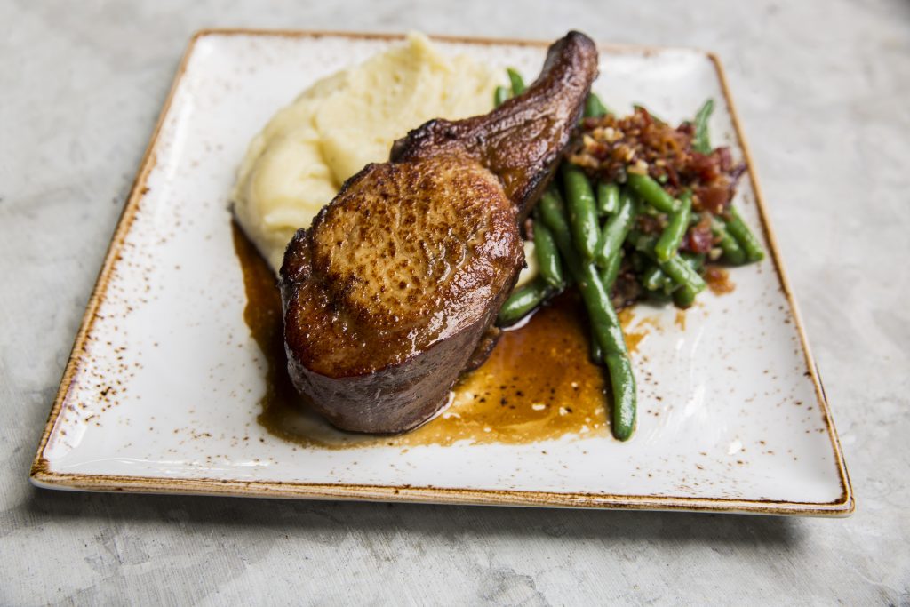 Indulge with State Fare's double-cut pork chop. 