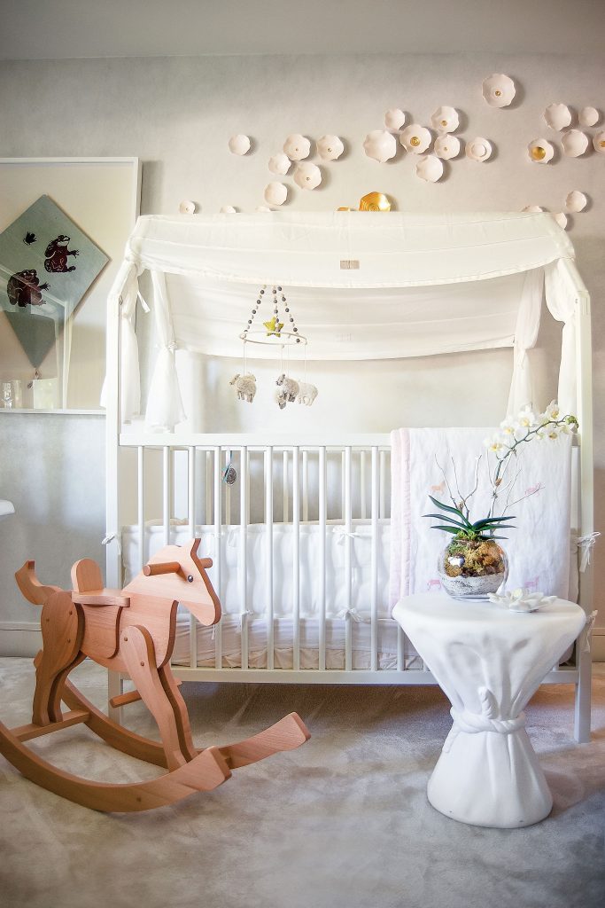 In Alicia’s bedroom, the Stokke crib converts into a twin bed. John Dickenson plaster table was a gift from David and Ann Sutherland. Lucrecia Waggoner’s custom-created Clouds
artwork in porcelain and gold. Hermès rocking horse was a gift from Alicia’s godfather, Robert Hallam Jr.