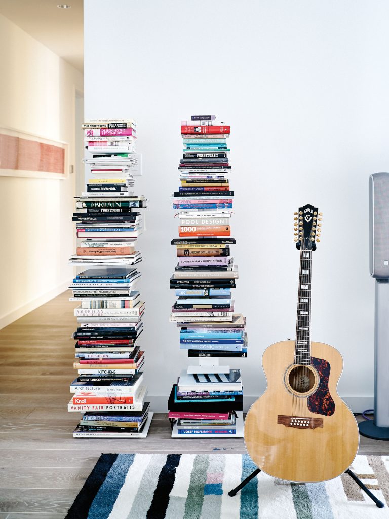 In the sitting room, one of a pair of spruce and bird’s-eye maple 12-string Guild guitars. Braun’s favorite architecture and design books are stacked at the ready. In background, Makoto Sasaki’s "12 Hour Heartbeat" lithograph.