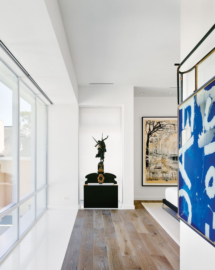 In the master bedroom, circa-1870 bronze-and-gilt Gloria Victis figure and clock by Antonin Mercié. Kent Dorn’s Death Valley Daze, 2012, from McClain Gallery. Rob Fischer’s Blue Luggage, 2014.