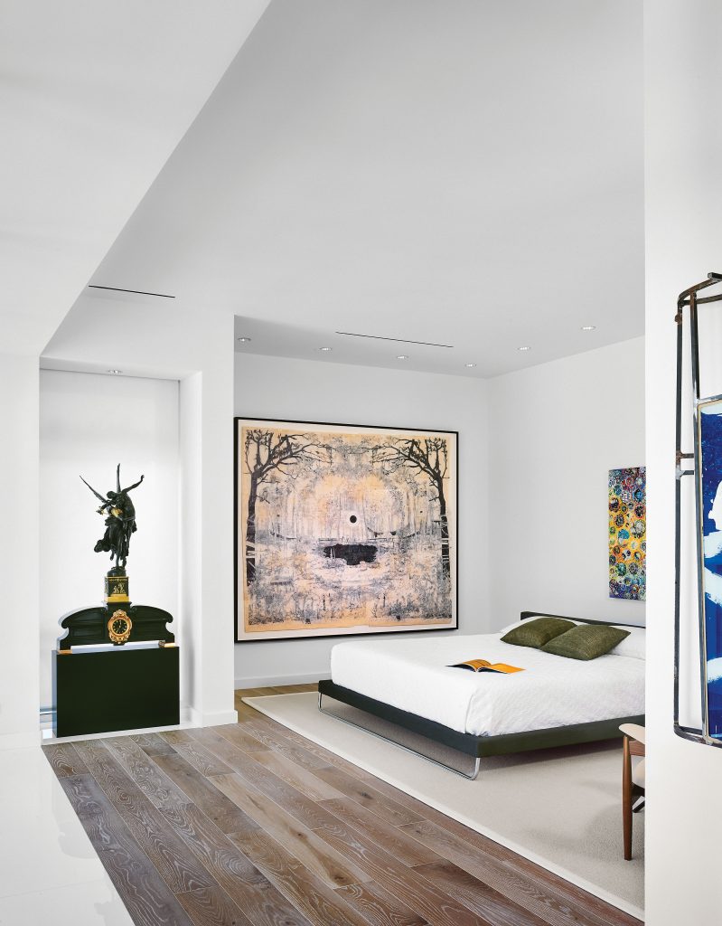 In the master bedroom, circa-1870 bronze-and-gilt Gloria Victis figure and clock by Antonin Mercié. Kent Dorn's Death Valley Daze, 2012. Nobu Fukui's Wonder, 2014, above the bed. 