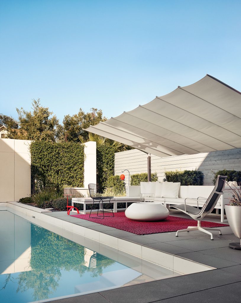 The courtyard’s retractable Flexy canopy is by FIM Manufacturing. Knoll Bertoia chair, Ekitta red table, sectional lounge by Gandia Blasco from Internum, Eames outdoor lounge by Herman Miller from Office Pavilion. Bubble portable firepit by Planika from Internum. Birdfeeder by J Schatz. Rug from Internum.