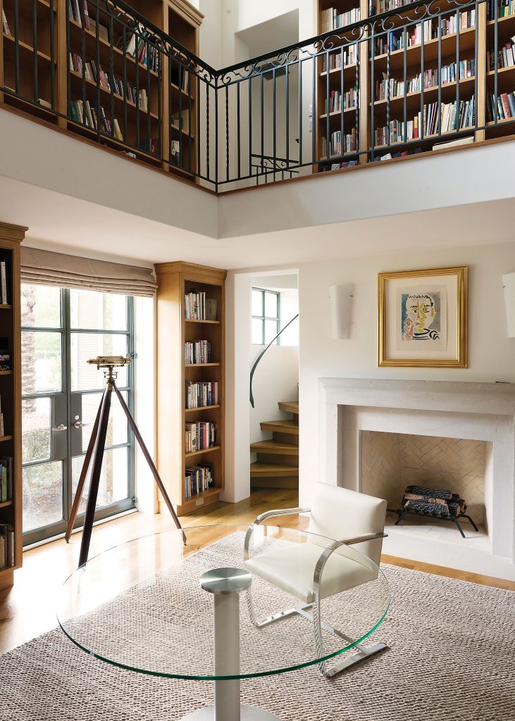 A glass table and chairs from Design Within Reach are in the two-story library. Over the fireplace is a pencil-signed and numbered Fumar lithograph by Picasso. An antique telescope sits at the window. The collection of volumes testifies to the Kramers’ interest in travel, world affairs and other cultures. Lauren says of the couple’s 46-year marriage, “We have gone to some off-the-beaten track places like Myanmar, Ethiopia and Saudi Arabia.”