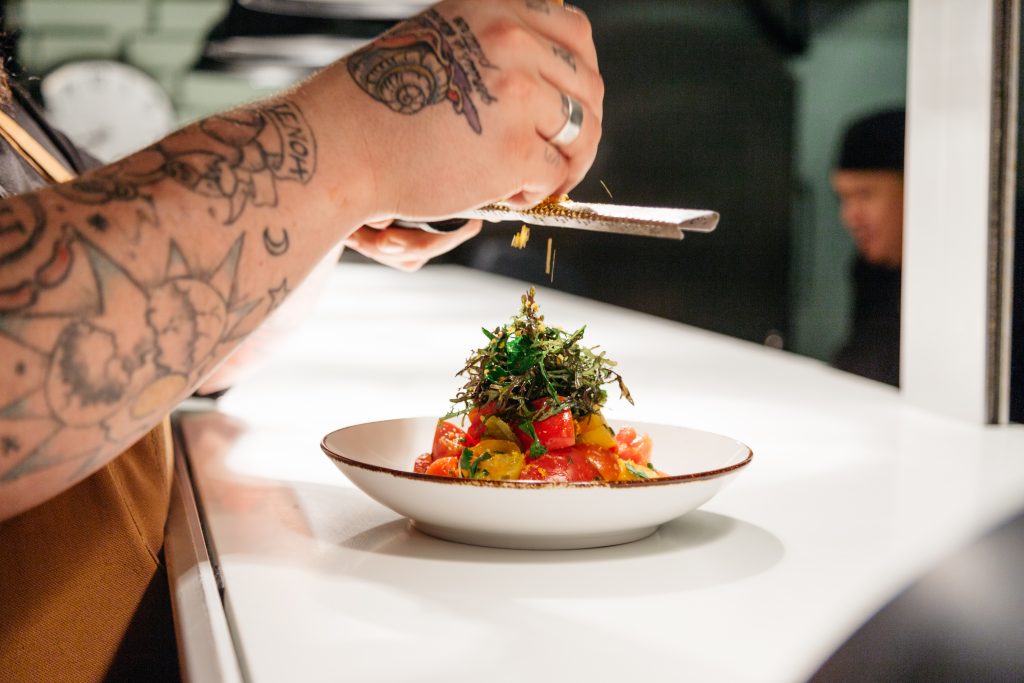 Chef Kearney garnishes a dish. (Photo courtesy Cedar Grove) 