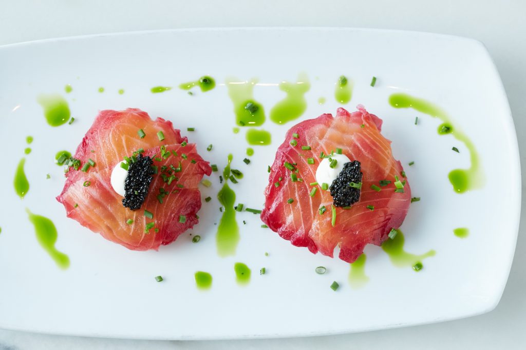 Bistro 31's Red-beet-cured Pacific salmon with potato latkes, sour cream, and Paddlefish caviar