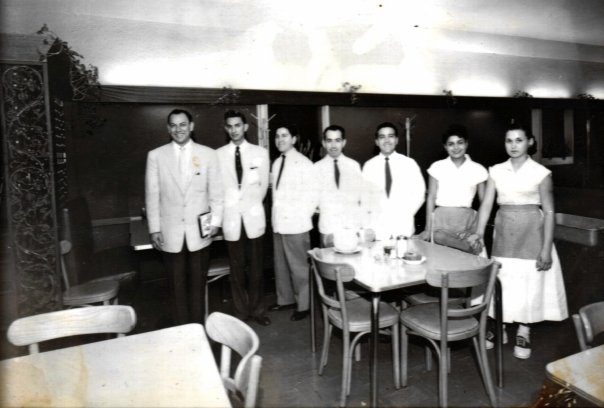 Raul Molina Jr. stand with his Molina's staff.