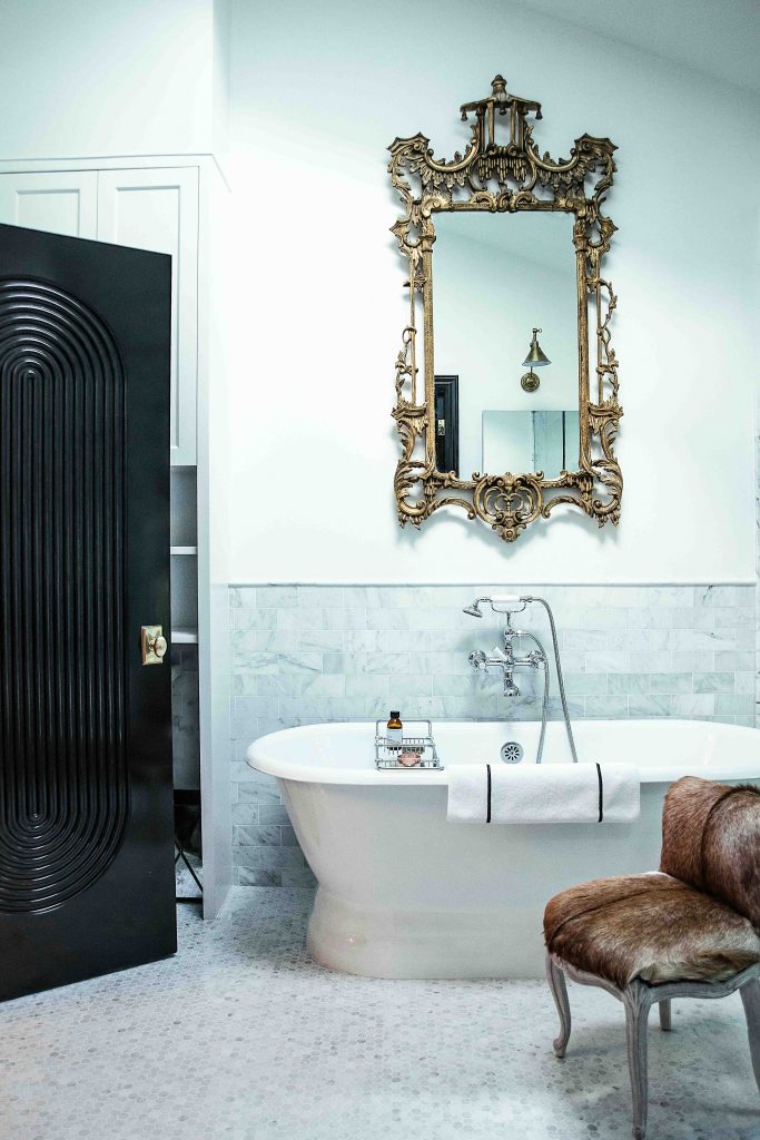 In the master bath, Waterworks Highgate fixtures; Signature Hardware tub; vintage alvaged door; French chair in cowhide from Calypso St. Barth; antique pagoda mirror from Circa Who, Miami