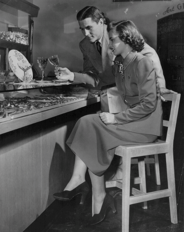 SMU alum and Heisman Trophy winner Doak Walker and fiancée Norma Peterson (both Highland Park High School grads) shop for their wedding china at Arthur A. Everts Co. jewelry store in Highland Park Village, 1950. Walker opened Doak Walker Sports Center in HP Village the following year.