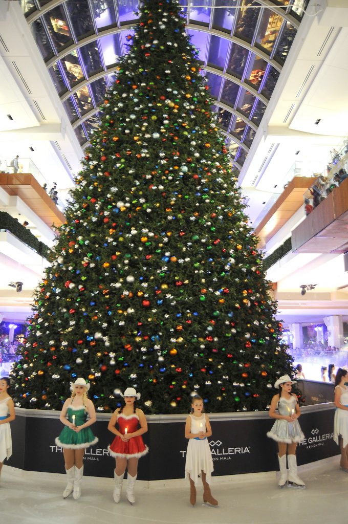 The Galleria Christmas tree's branches get lots of loving care.